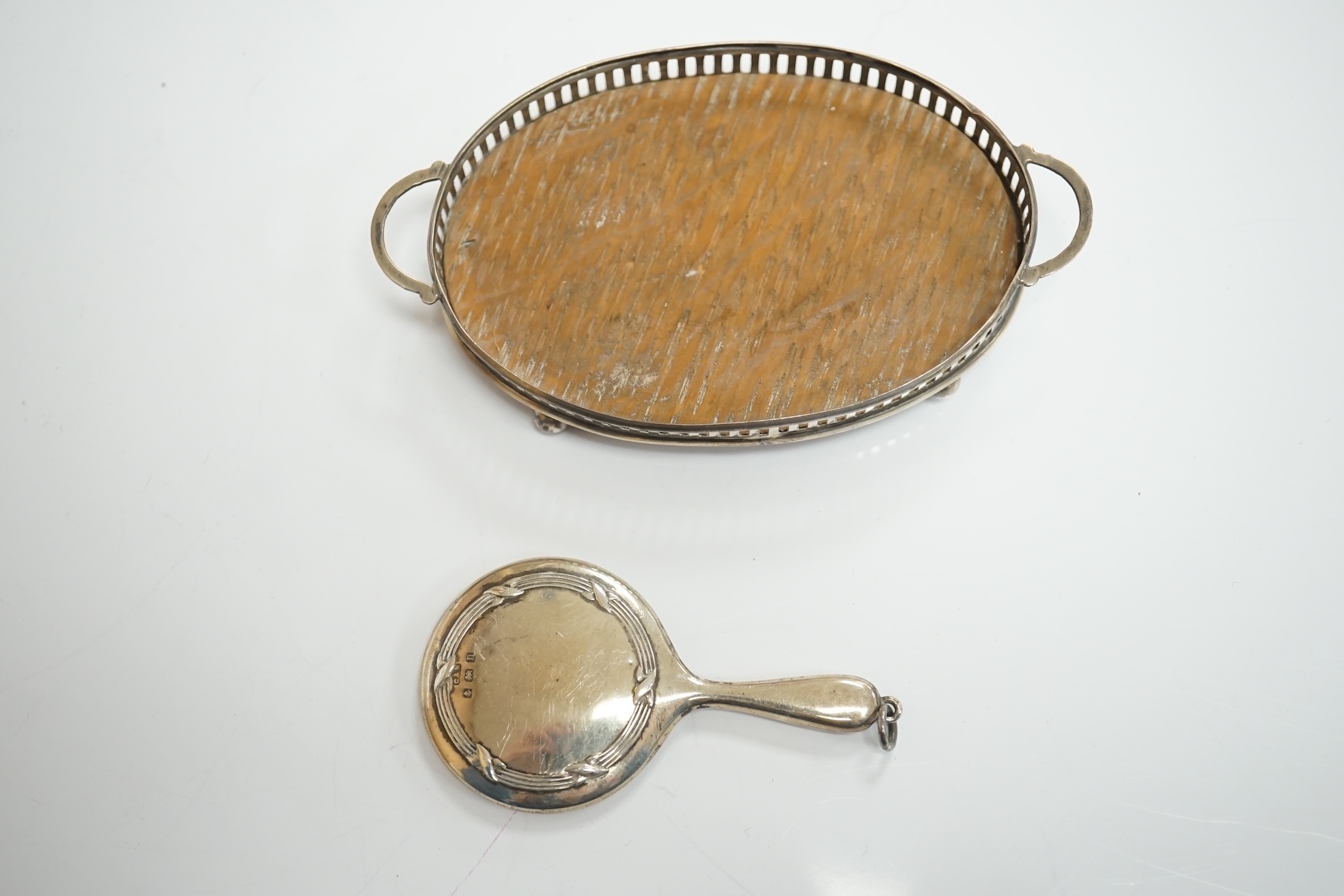 A collection of miniature silver including a three piece tea set and two handled tray by Saunders & Shepherd, Birmingham, 1904, tray 9.8cm, together with pepperettes including saucepan, candlesticks, hand mirror, etc. Co